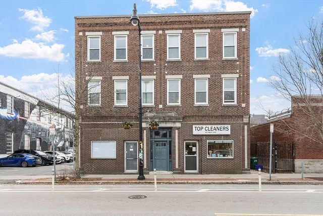 a front view of a building with garage and windows