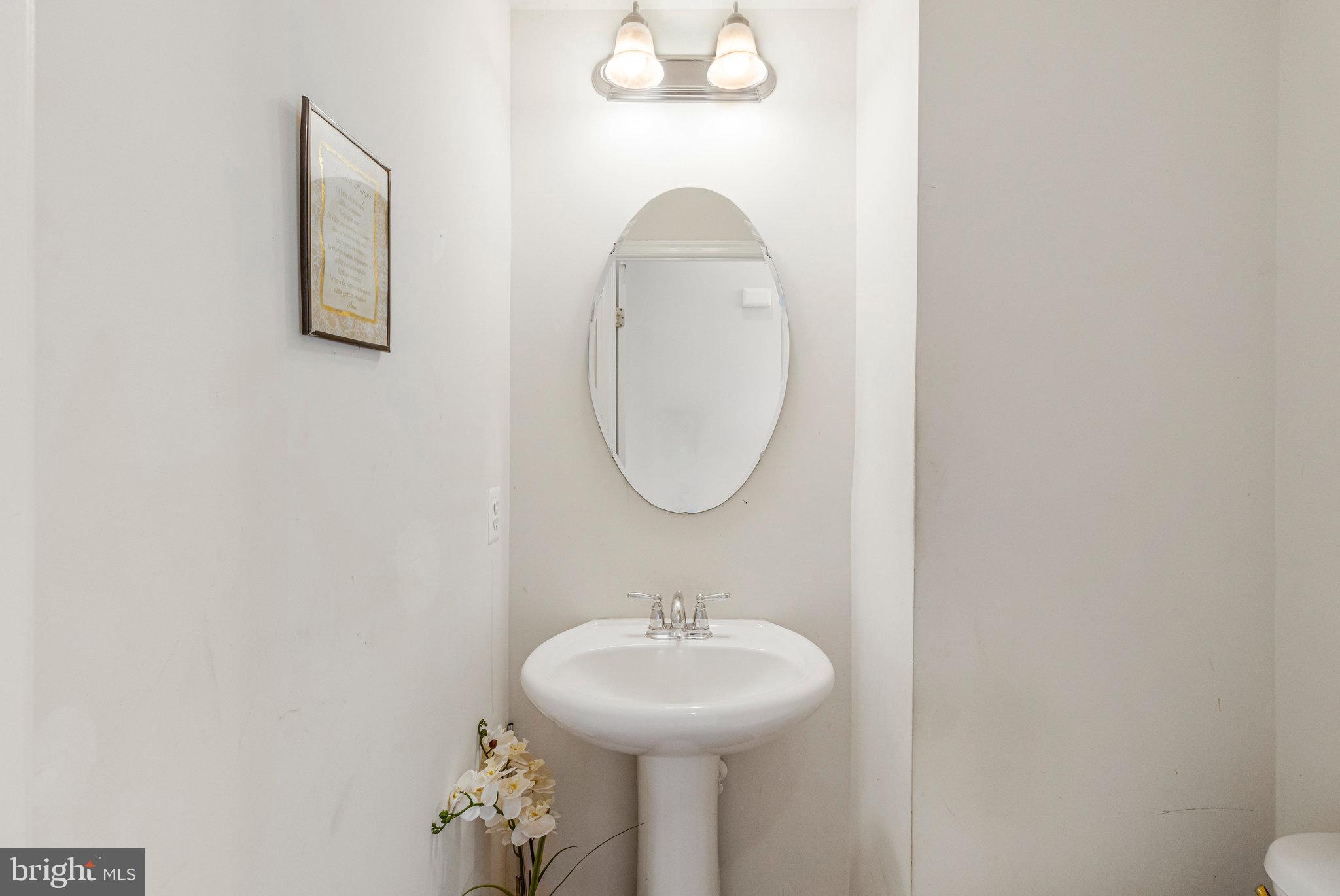 4615 Cimmaron Greenfields Drive Bowie, MD 20720 - Photo 12 of 27 a bathroom with a sink and mirror