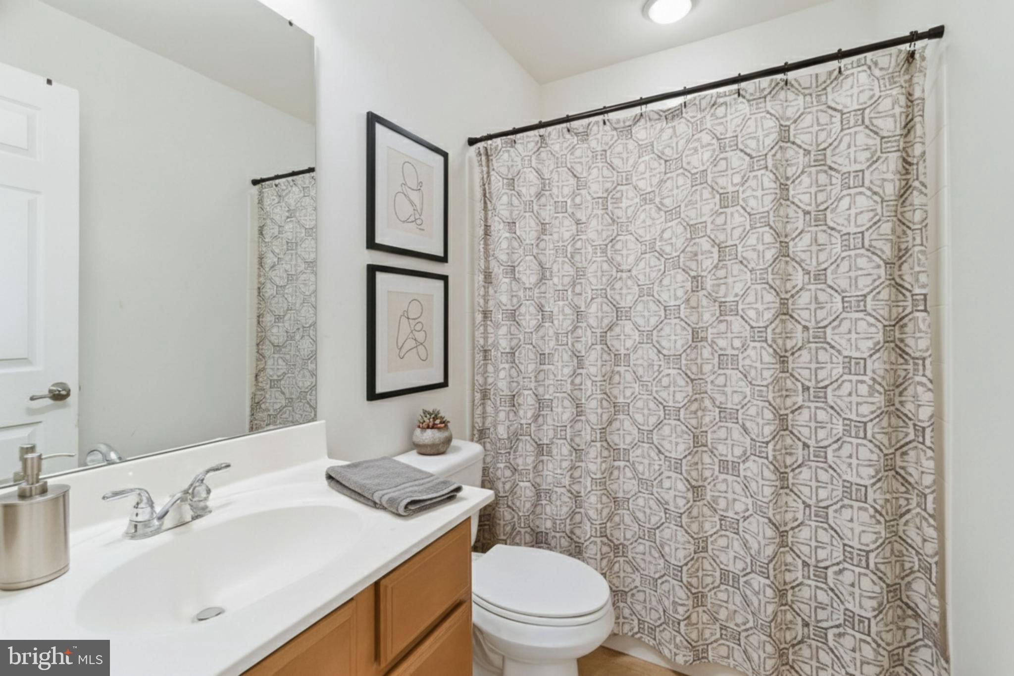 4615 Cimmaron Greenfields Drive Bowie, MD 20720 - Photo 19 of 27 a bathroom with a toilet sink and mirror