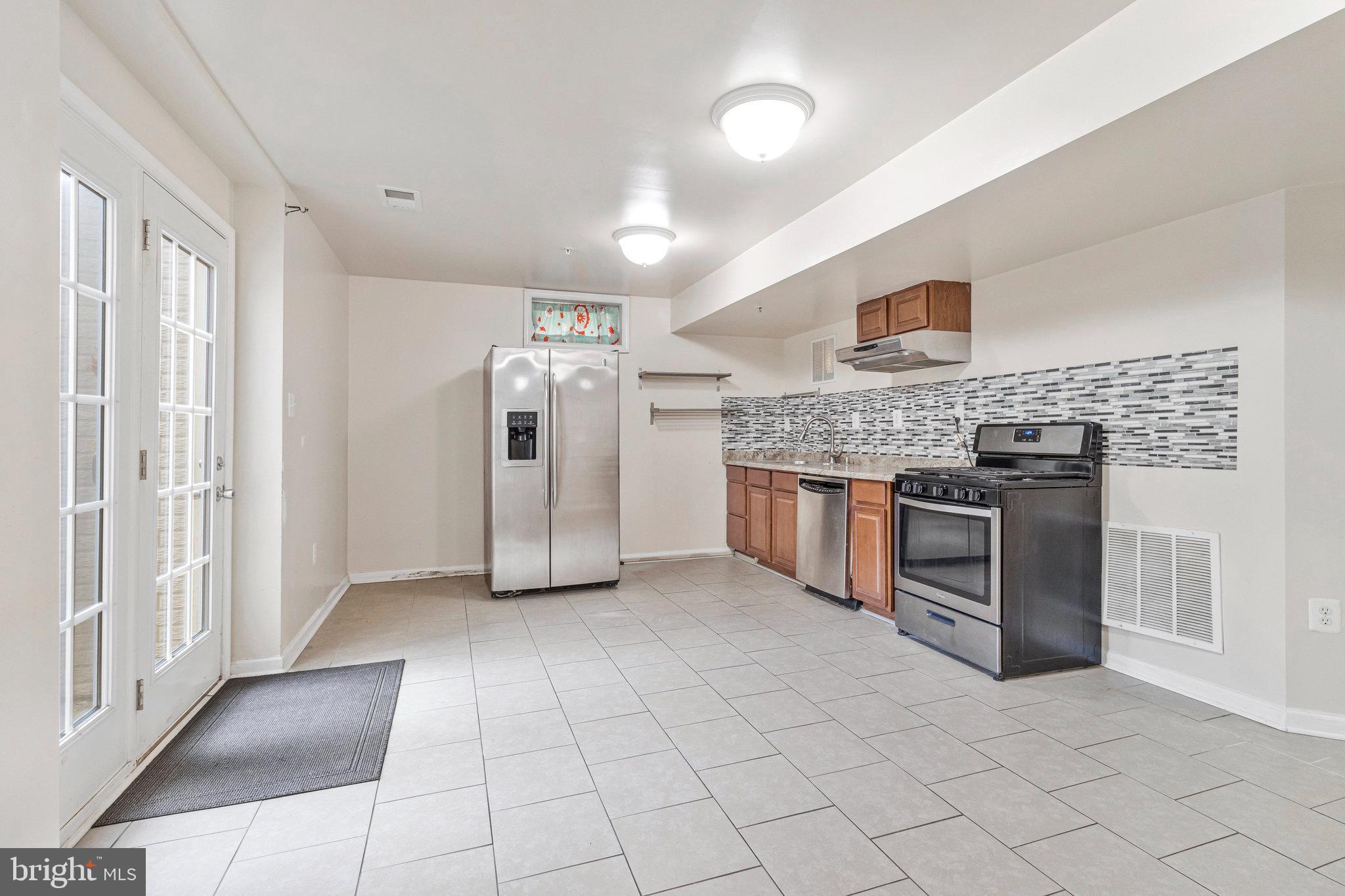 4615 Cimmaron Greenfields Drive Bowie, MD 20720 - Photo 21 of 27 a view of a kitchen with stainless steel appliances granite countertop a stove and a refrigerator