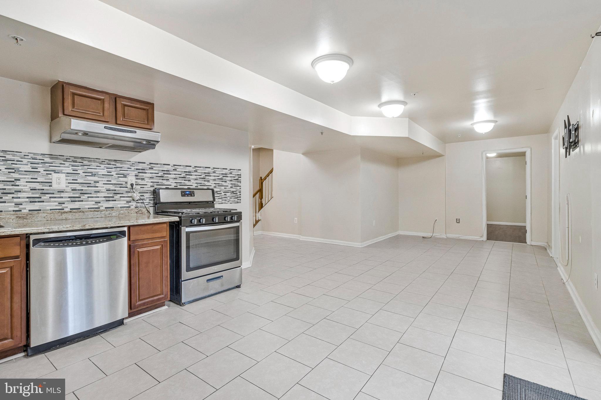 4615 Cimmaron Greenfields Drive Bowie, MD 20720 - Photo 22 of 27 a kitchen with stainless steel appliances granite countertop a stove a sink and a refrigerator