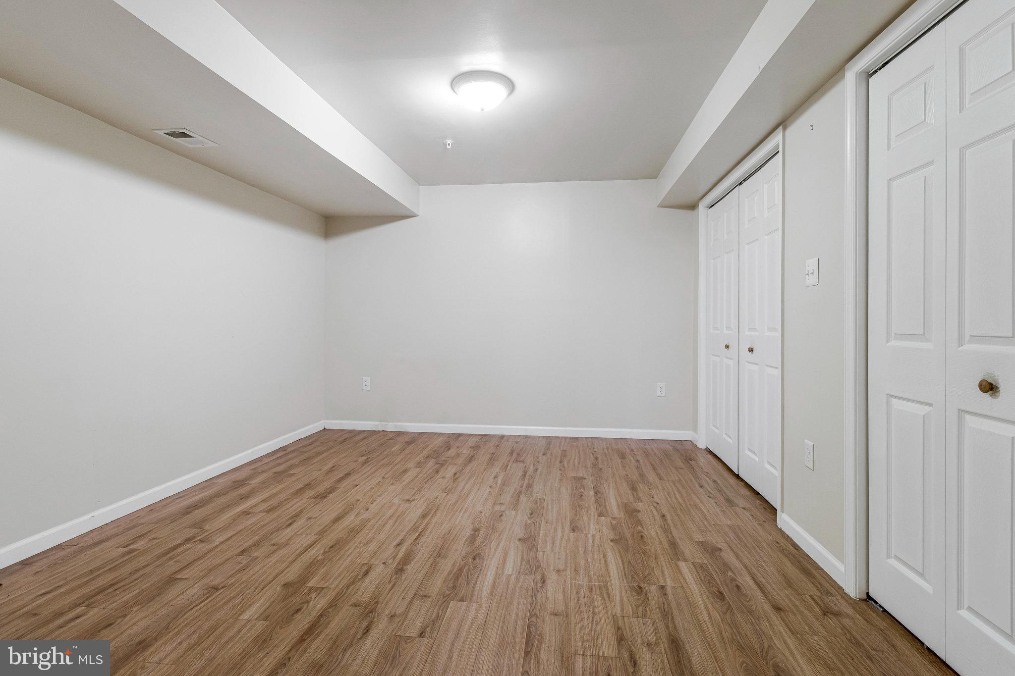 4615 Cimmaron Greenfields Drive Bowie, MD 20720 - Photo 23 of 27 a view of an empty room with wooden floor