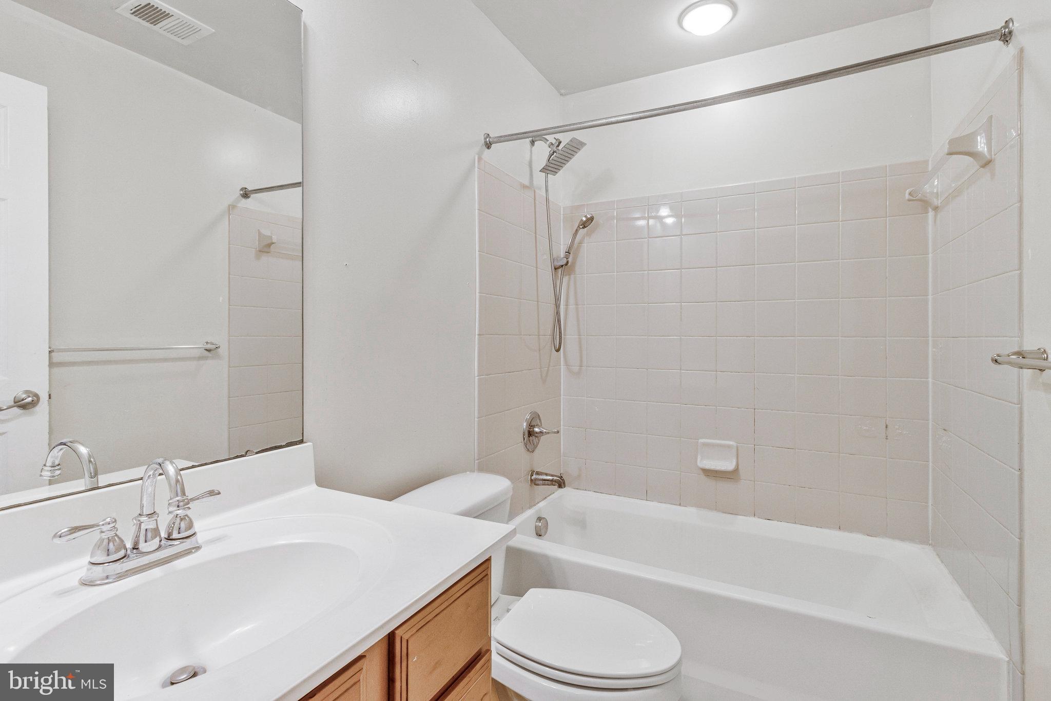 4615 Cimmaron Greenfields Drive Bowie, MD 20720 - Photo 25 of 27 a bathroom with a sink a toilet and a bathtub