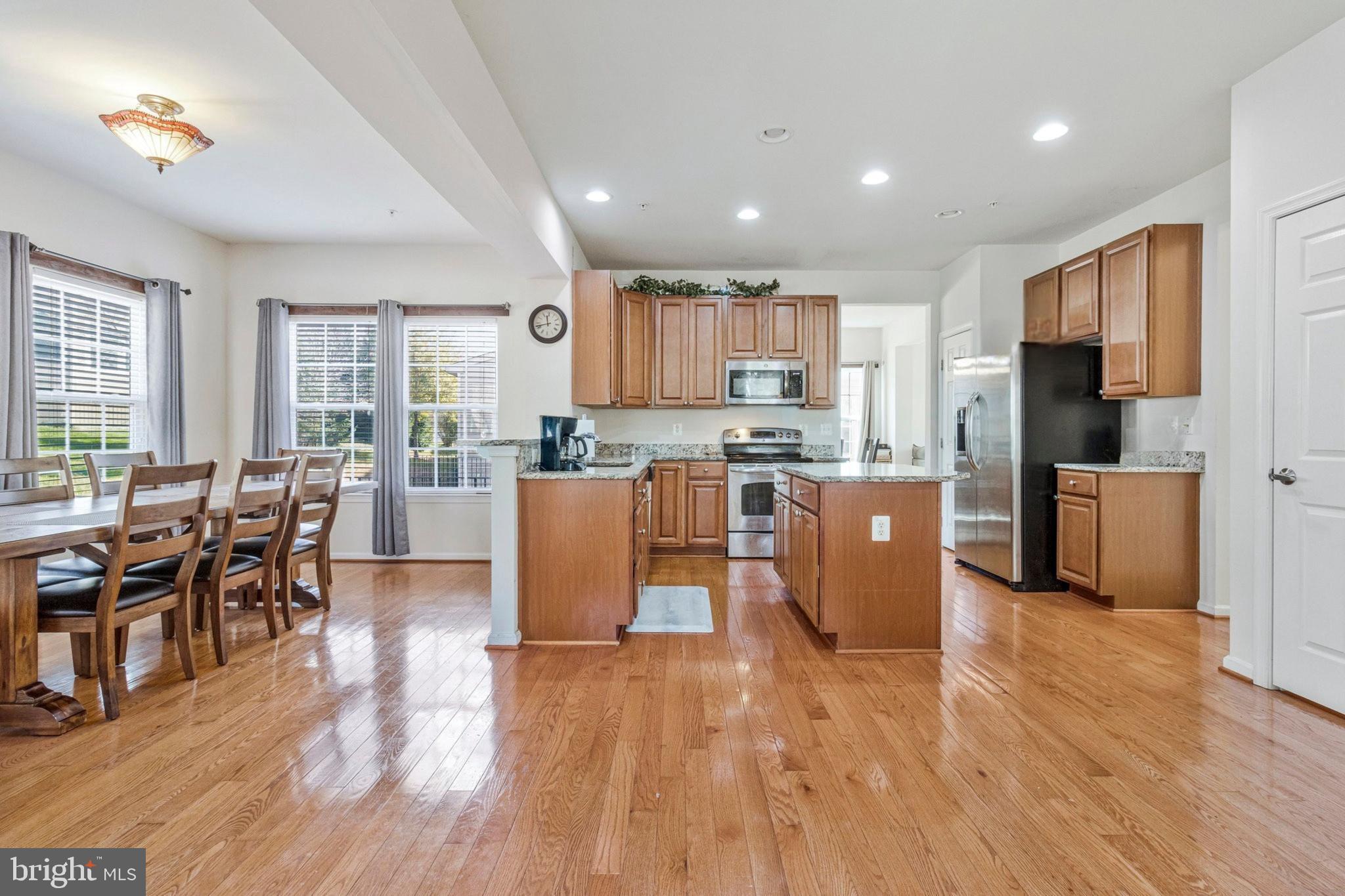 4615 Cimmaron Greenfields Drive Bowie, MD 20720 - Photo 3 of 27 a kitchen with stainless steel appliances wooden floors and wooden cabinets