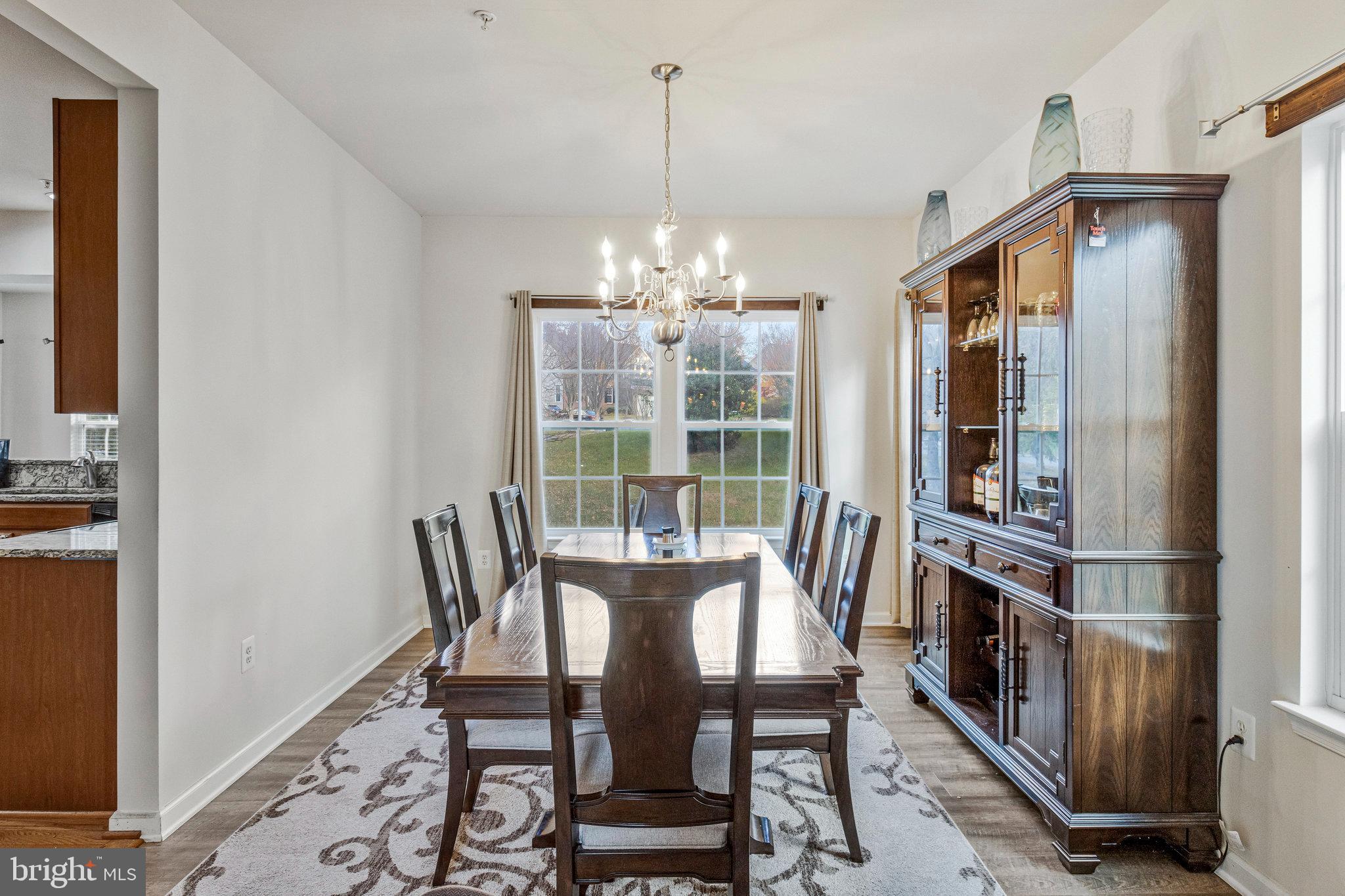 4615 Cimmaron Greenfields Drive Bowie, MD 20720 - Photo 7 of 27 a view of a dining room with furniture window and wooden floor