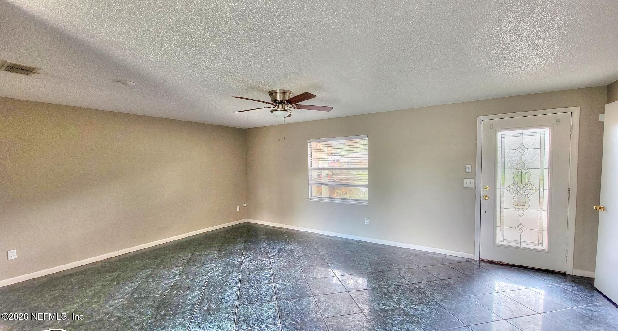 2472 Fernside Road Jacksonville, FL 32246 - Photo 4 of 16 wooden floor in an empty room with a window