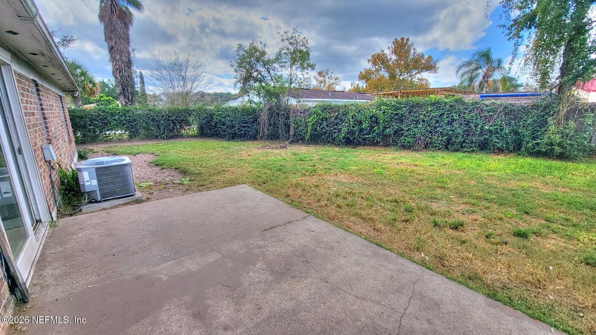 2472 Fernside Road Jacksonville, FL 32246 - Photo 5 of 16 a view of backyard with plants and outdoor seating