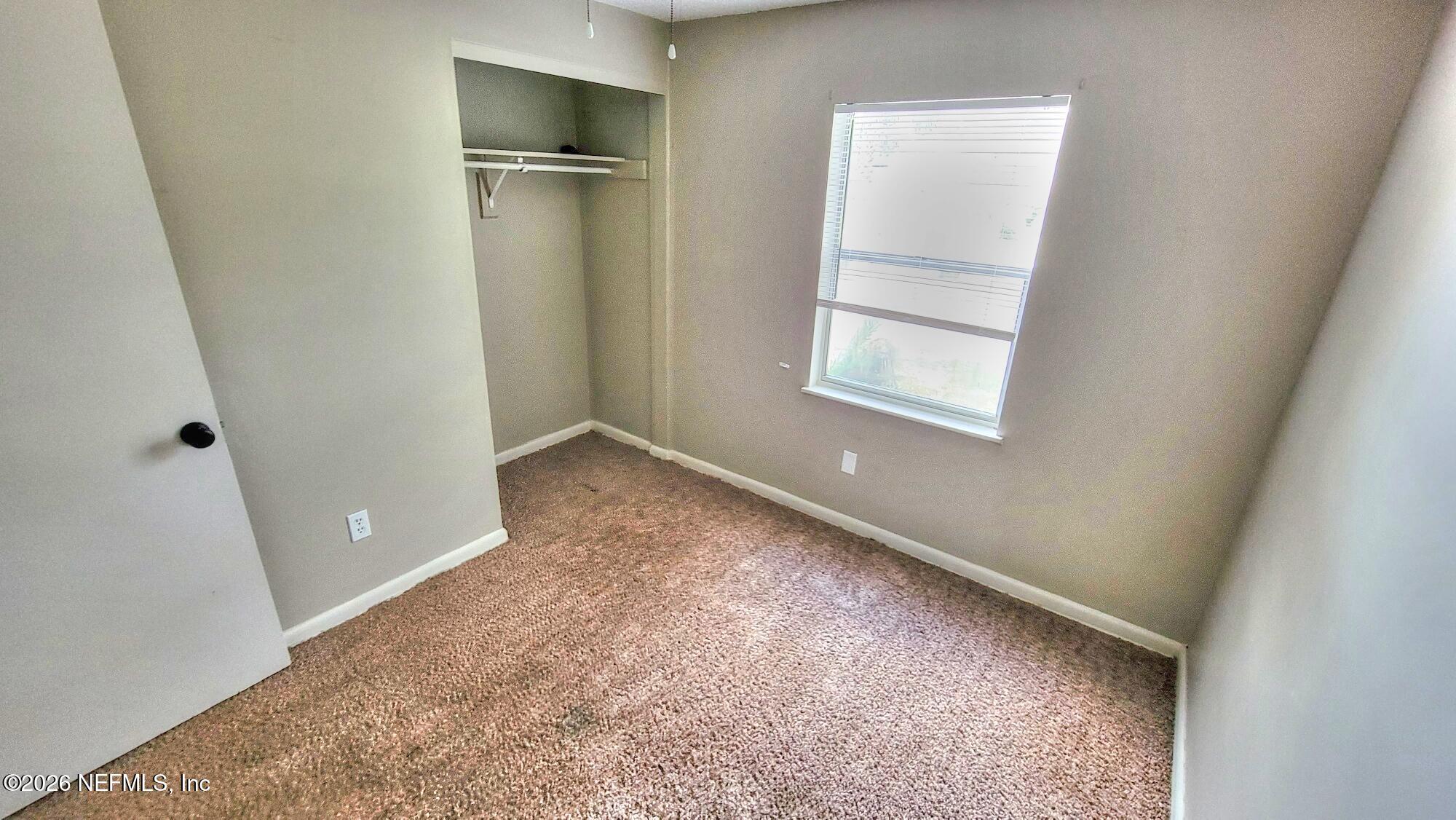 2472 Fernside Road Jacksonville, FL 32246 - Photo 10 of 16 an empty room with windows and closet