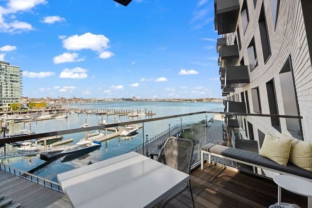 a view of a terrace with wooden floor and city view