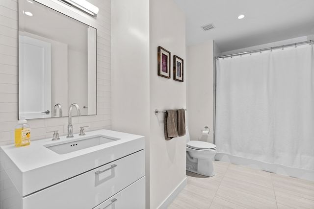 a bathroom with a sink toilet and vanity
