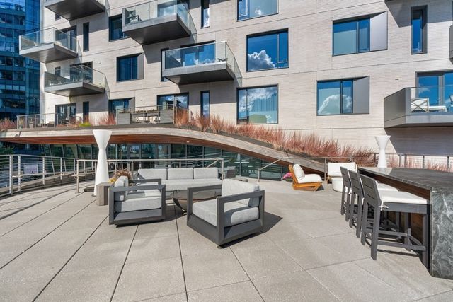 a kitchen with stainless steel appliances kitchen island a large island in the center