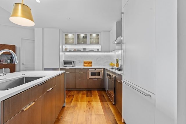a kitchen with a sink cabinets and appliances