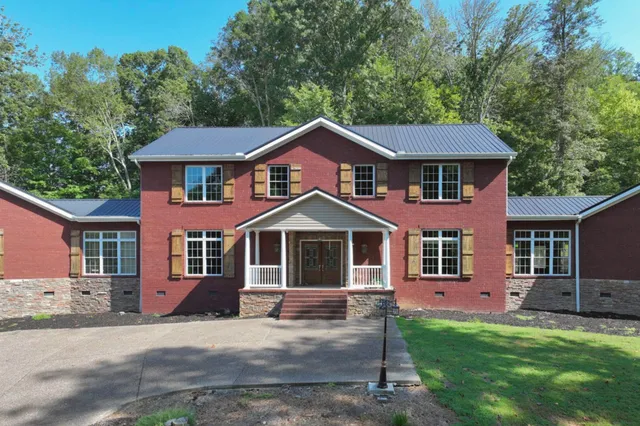 a front view of a house with a garden