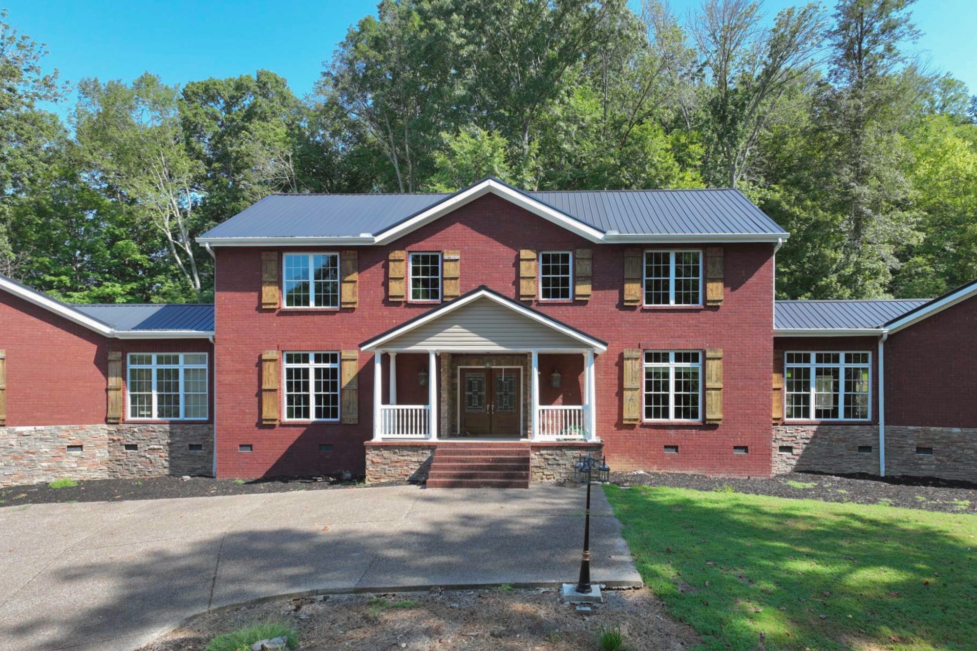 a front view of a house with a garden