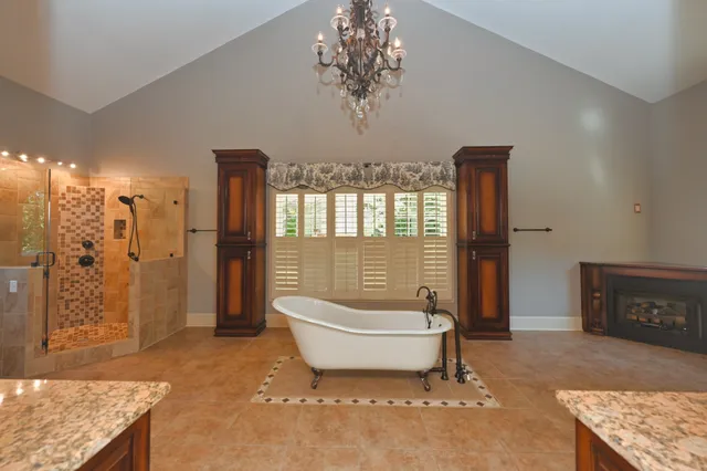 a bathroom with a glass shower door and a window