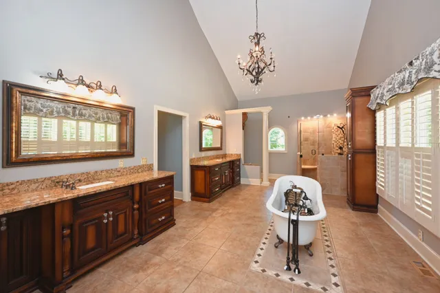 a living room with stainless steel appliances kitchen island granite countertop furniture and a flat screen tv