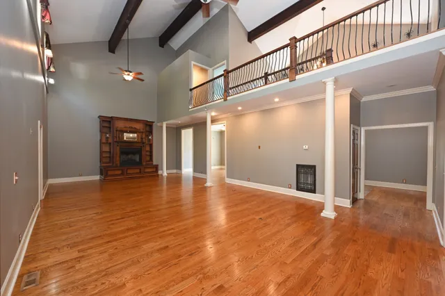 a bathroom with a granite countertop toilet sink and mirror