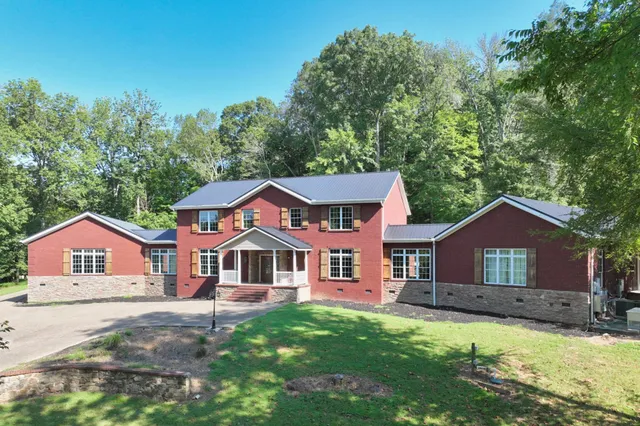 a front view of a house with a large window