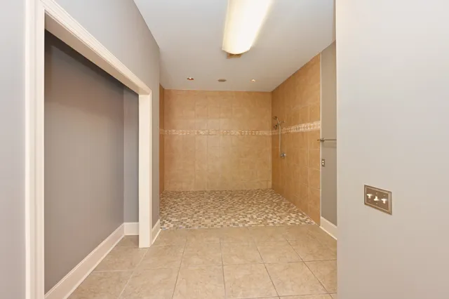 a view of a hallway with wooden floor and chandelier