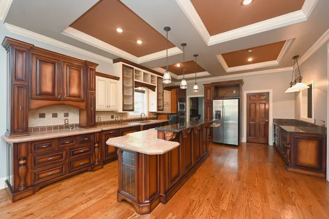 a kitchen with stainless steel appliances granite countertop a stove and cabinets