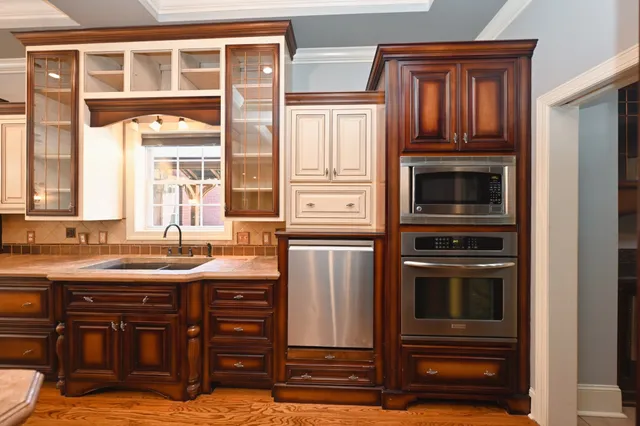 a kitchen with granite countertop a sink stove and cabinets