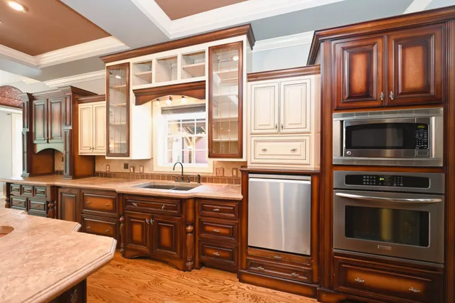 a kitchen with a sink a stove and cabinets