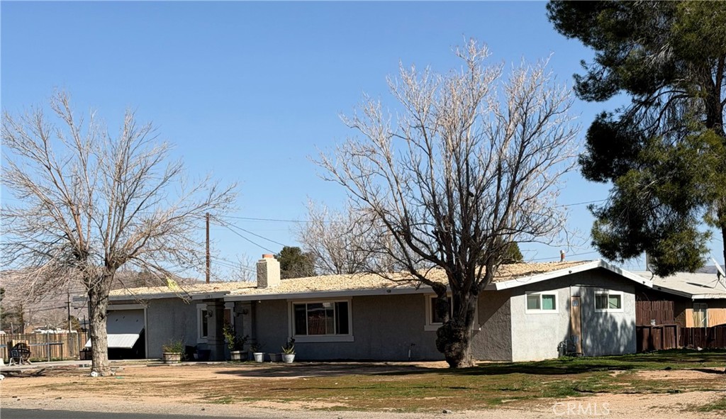 13981 Pawnee Road Apple Valley, CA 92307 - Photo 1 of 1 a view of a house with a yard and large tree