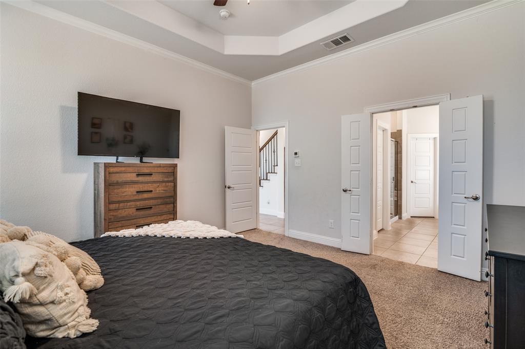 537 Declaration Way Fate, TX 75189 - Photo 14 of 39 a bedroom with a bed and a television