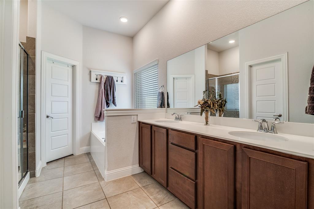 537 Declaration Way Fate, TX 75189 - Photo 15 of 39 a bathroom with a double vanity sink mirror and refrigerator