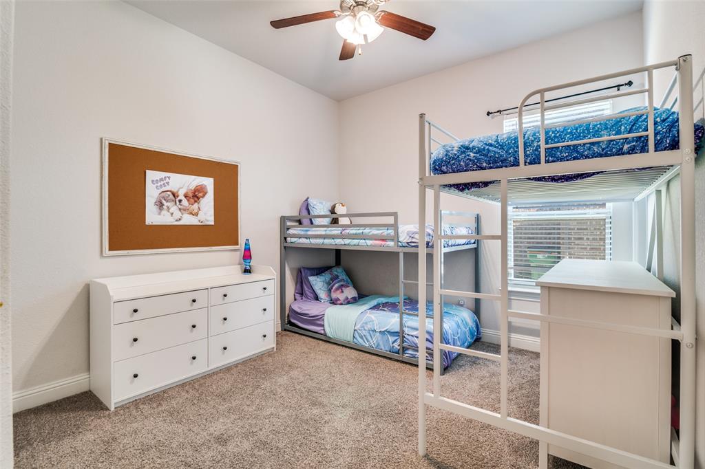 537 Declaration Way Fate, TX 75189 - Photo 24 of 39 a bedroom with furniture and a chandelier