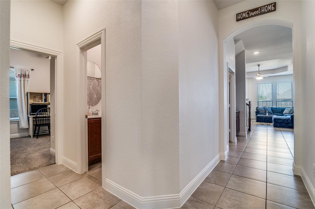 537 Declaration Way Fate, TX 75189 - Photo 27 of 39 a view of a hallway with furniture and a living room