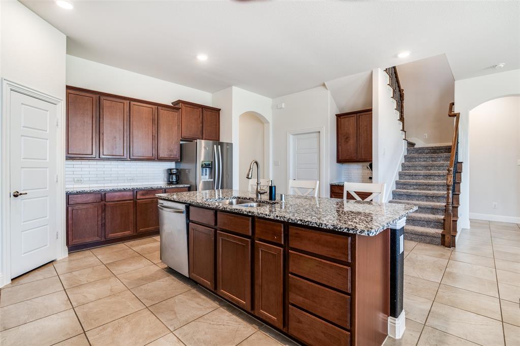 537 Declaration Way Fate, TX 75189 - Photo 8 of 39 a kitchen with stainless steel appliances granite countertop a sink and cabinets