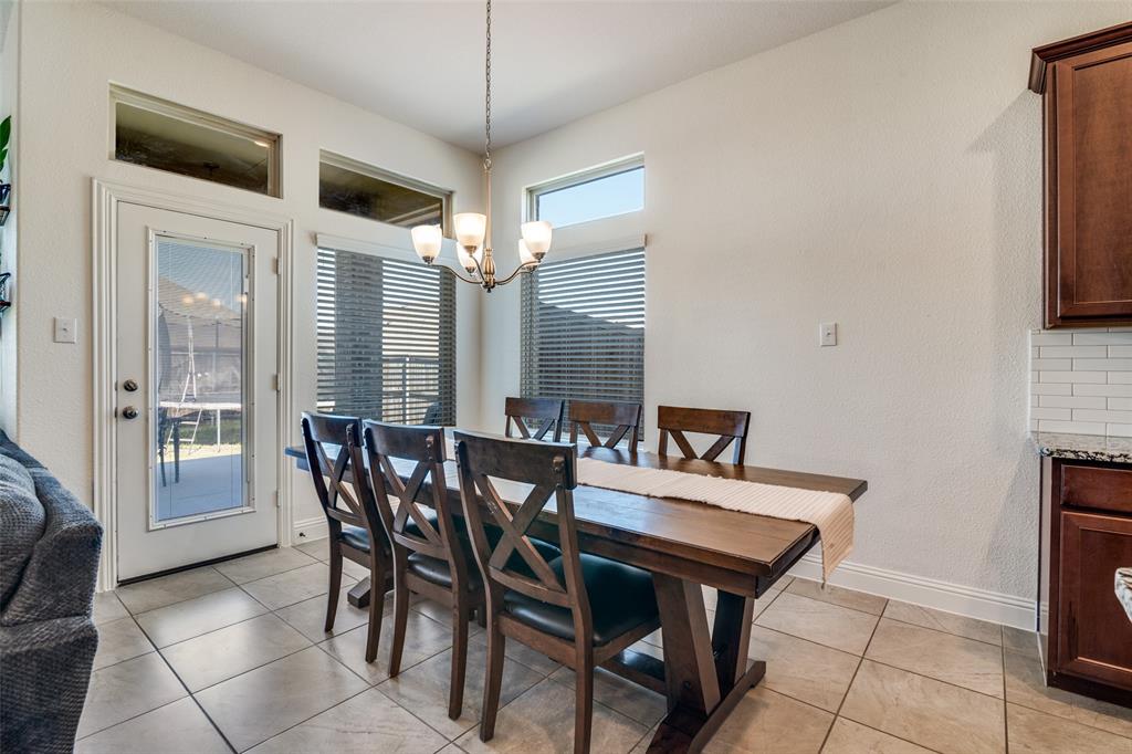 537 Declaration Way Fate, TX 75189 - Photo 9 of 39 a view of a dining room with furniture and a chandelier
