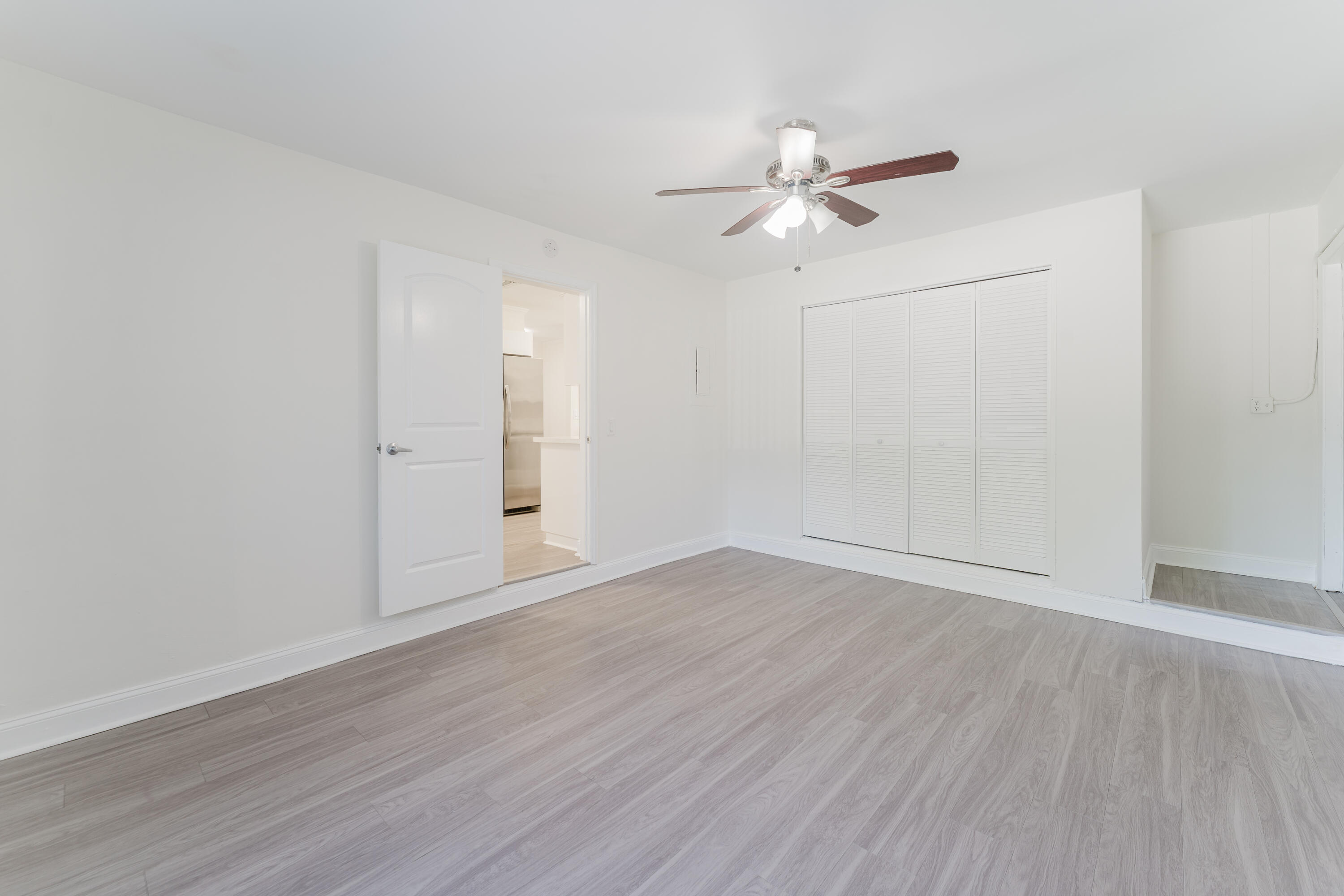 302 Northeast 36th Street Boca Raton, FL 33431 - Photo 11 of 40 an empty room with wooden floor fan and windows