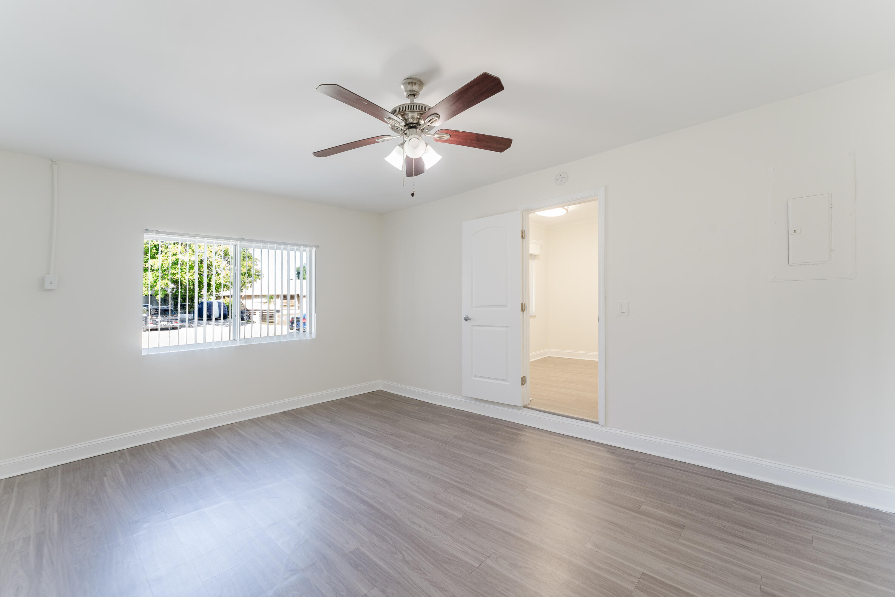 302 Northeast 36th Street Boca Raton, FL 33431 - Photo 13 of 40 a view of an empty room with wooden floor and a window