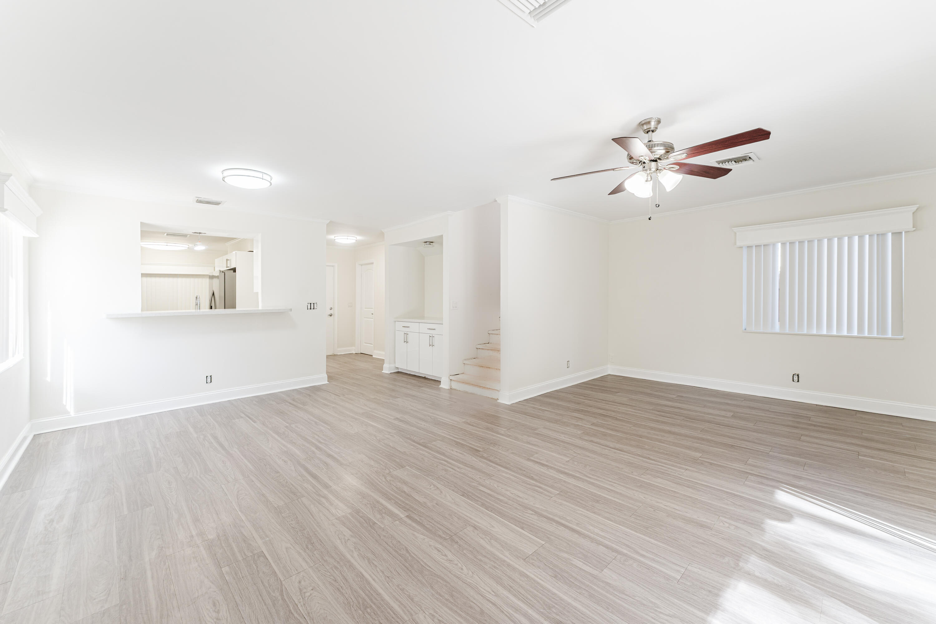 302 Northeast 36th Street Boca Raton, FL 33431 - Photo 16 of 40 a view of a kitchen with wooden floor and a ceiling fan