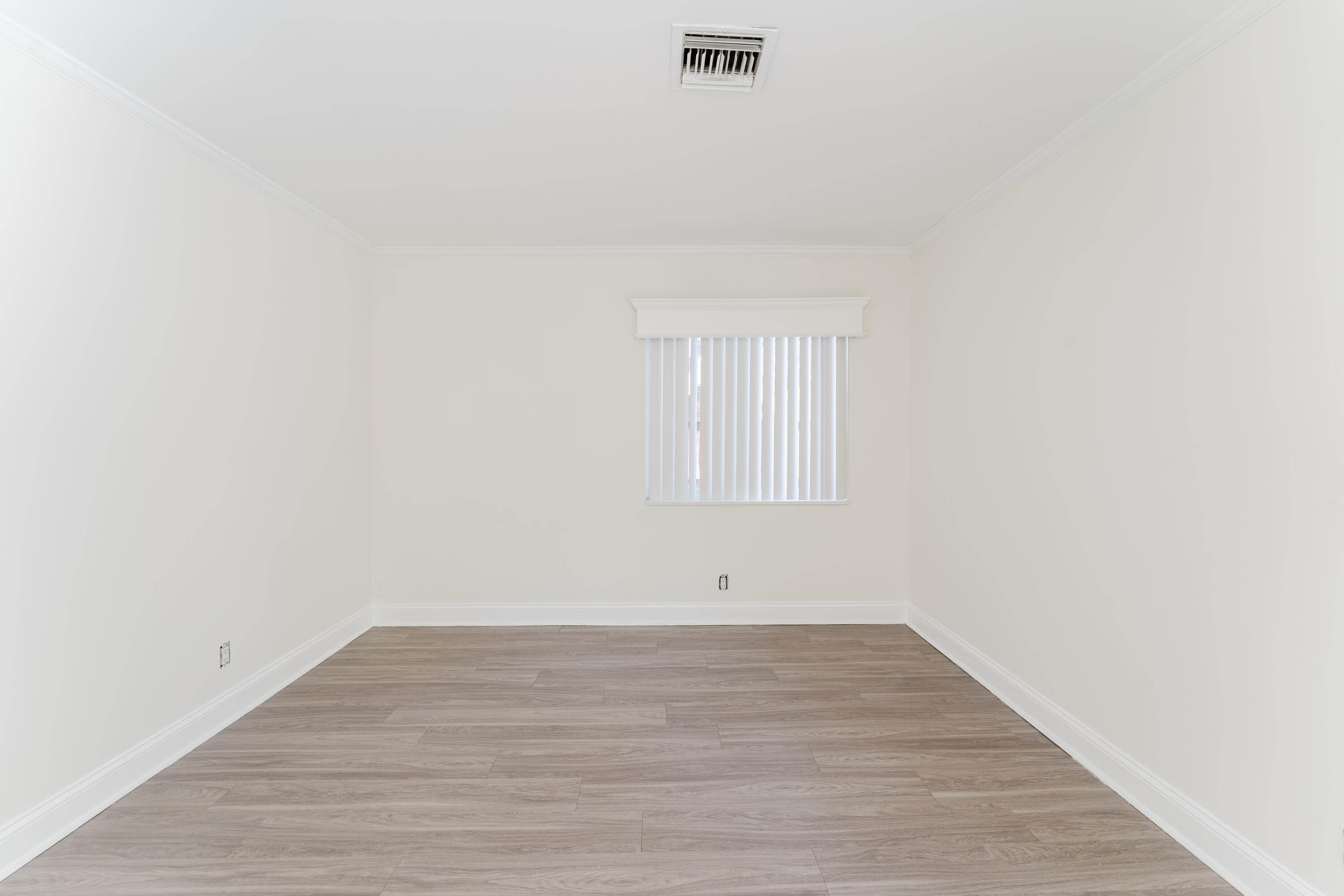302 Northeast 36th Street Boca Raton, FL 33431 - Photo 18 of 40 a view of an empty room with wooden floor and a window