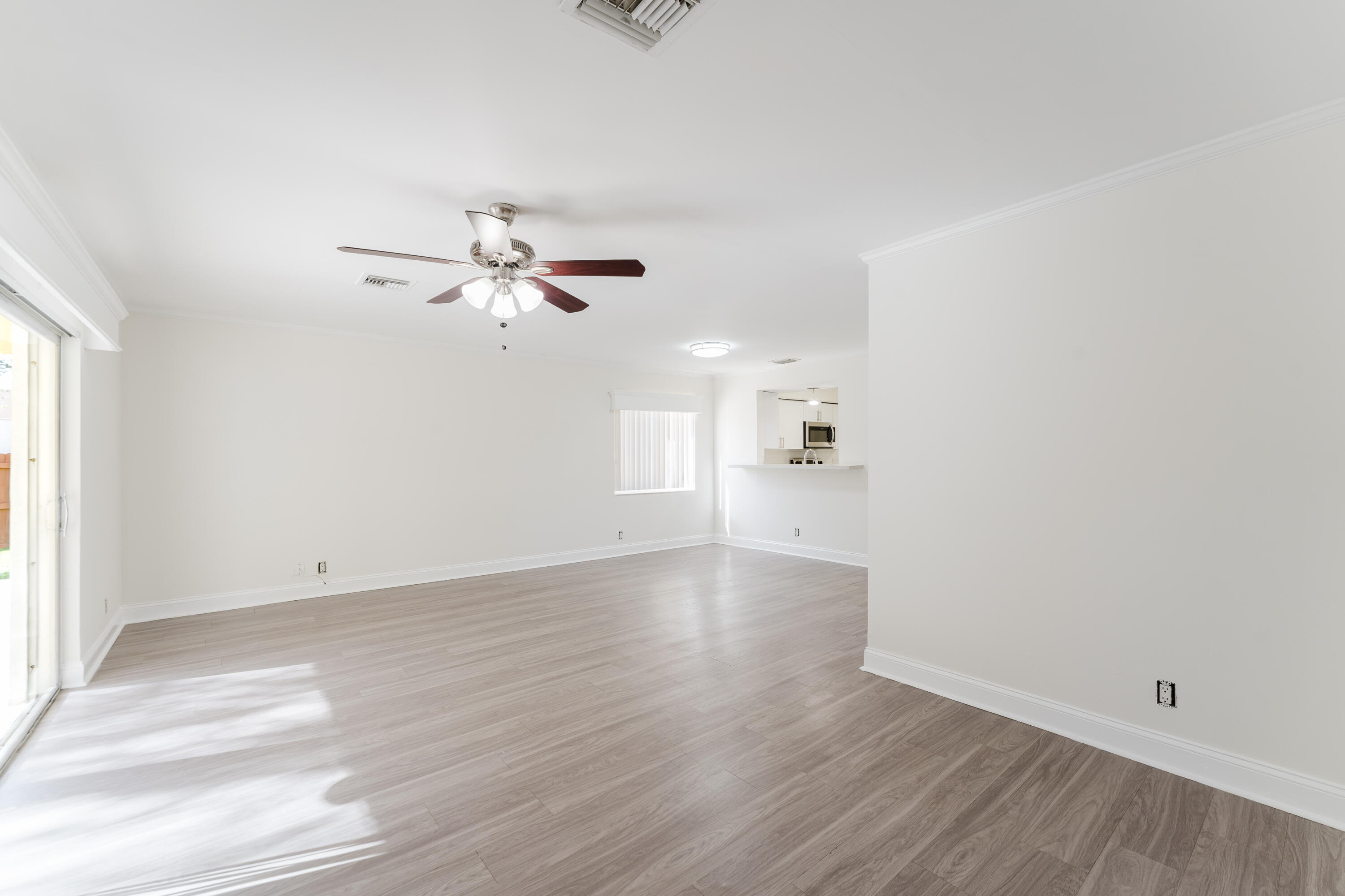 302 Northeast 36th Street Boca Raton, FL 33431 - Photo 19 of 40 a view of an empty room with wooden floor and a window