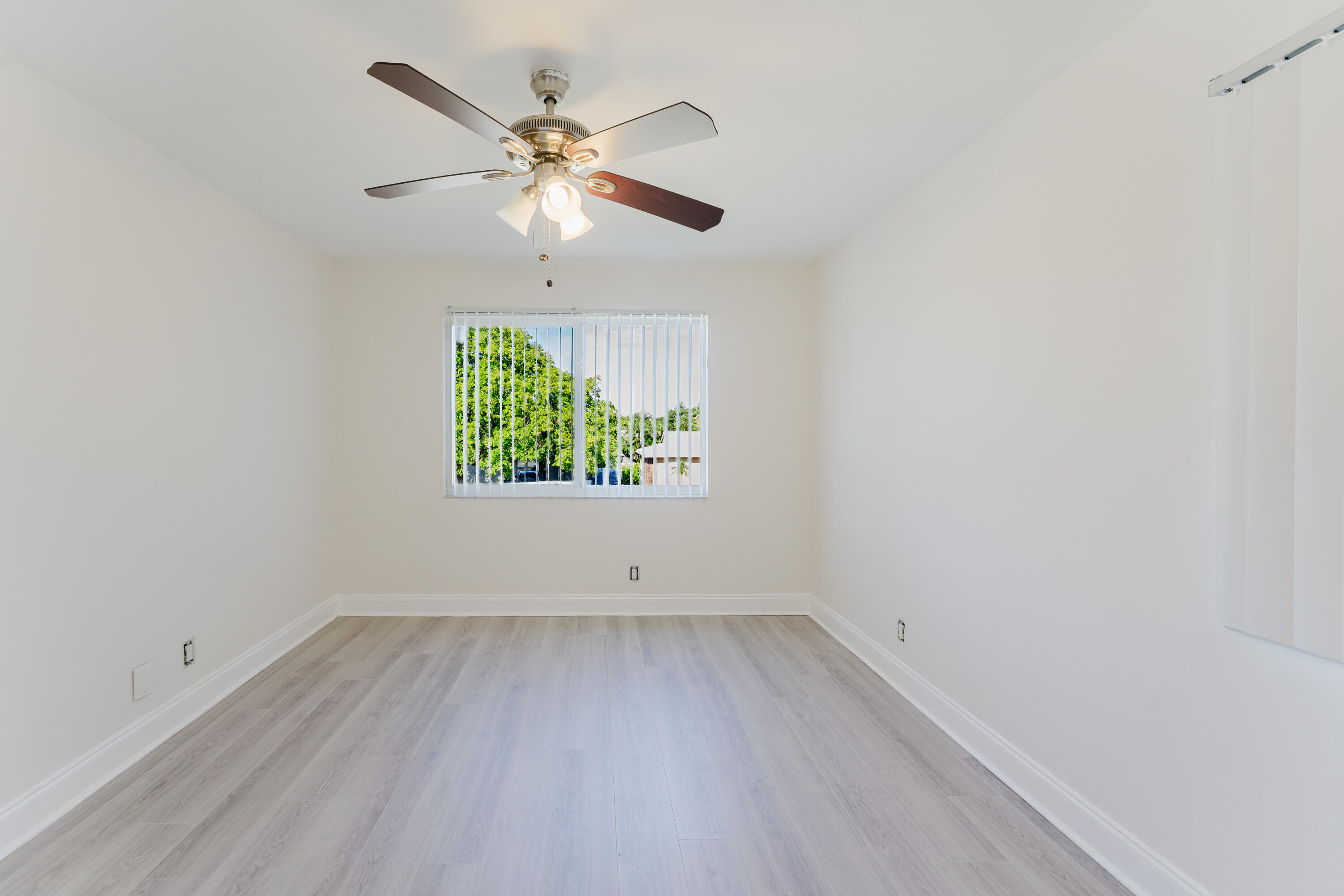 302 Northeast 36th Street Boca Raton, FL 33431 - Photo 21 of 40 wooden floor in an empty room with a window