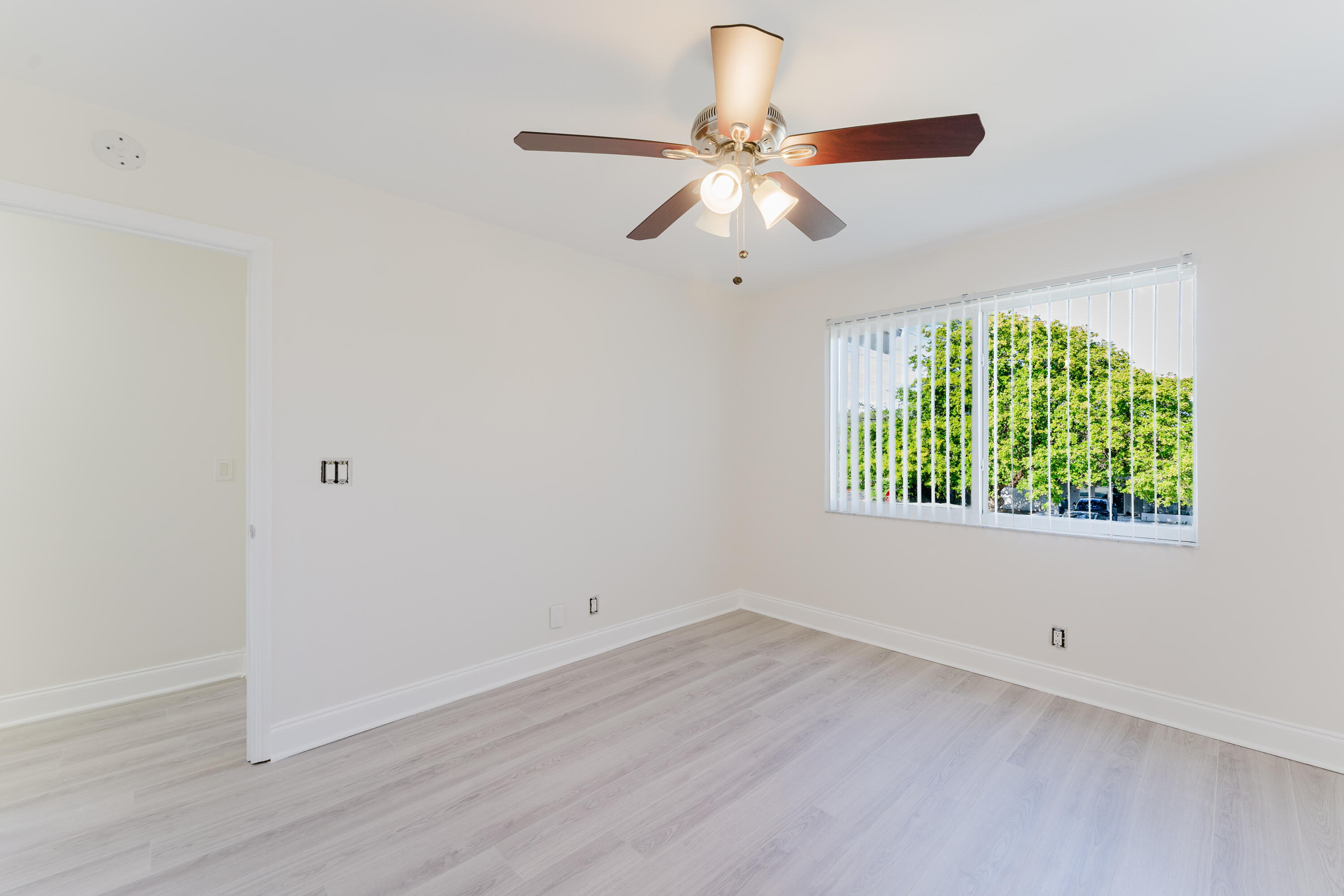 302 Northeast 36th Street Boca Raton, FL 33431 - Photo 22 of 40 wooden floor in an empty room with a window