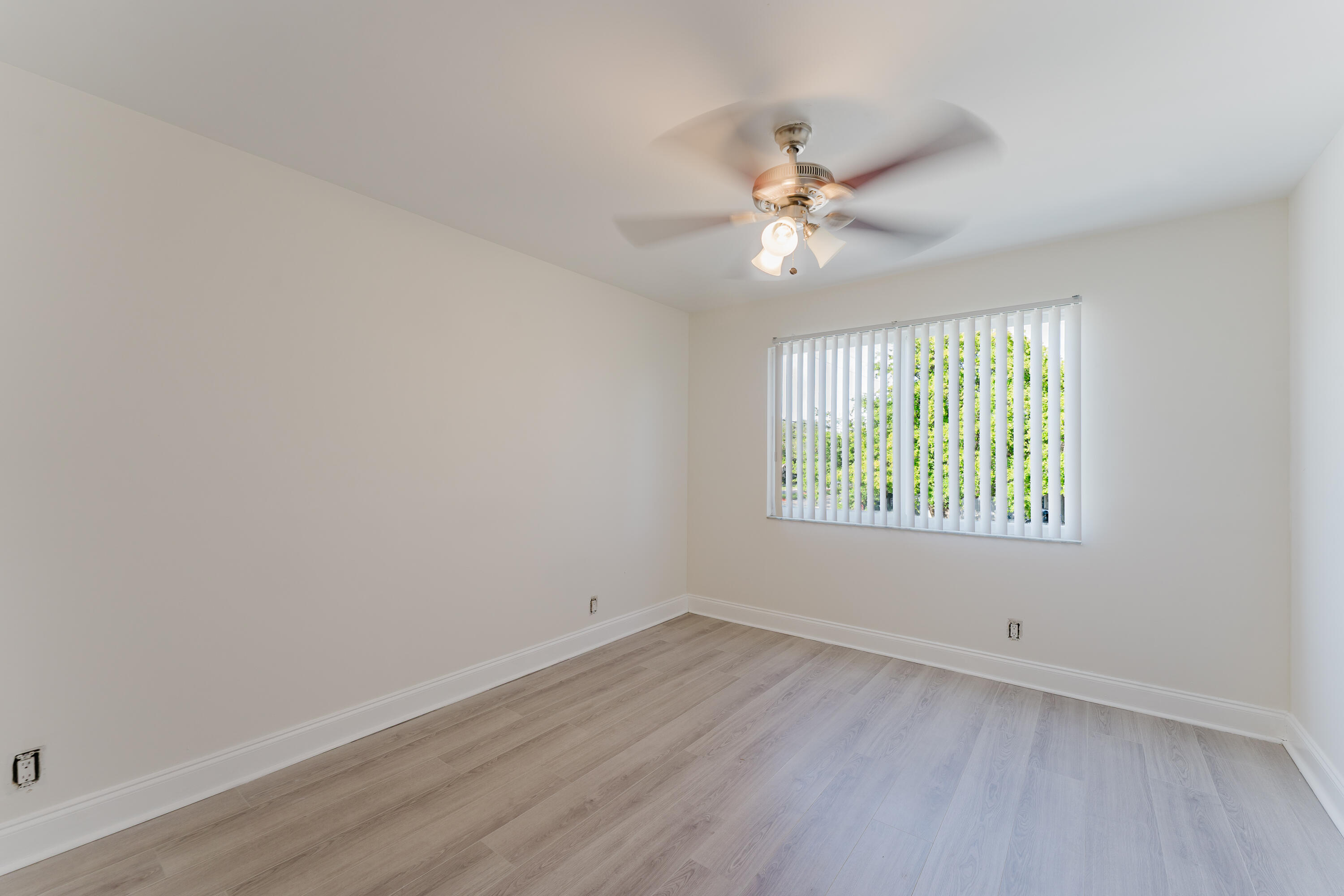 302 Northeast 36th Street Boca Raton, FL 33431 - Photo 23 of 40 wooden floor in an empty room with a window