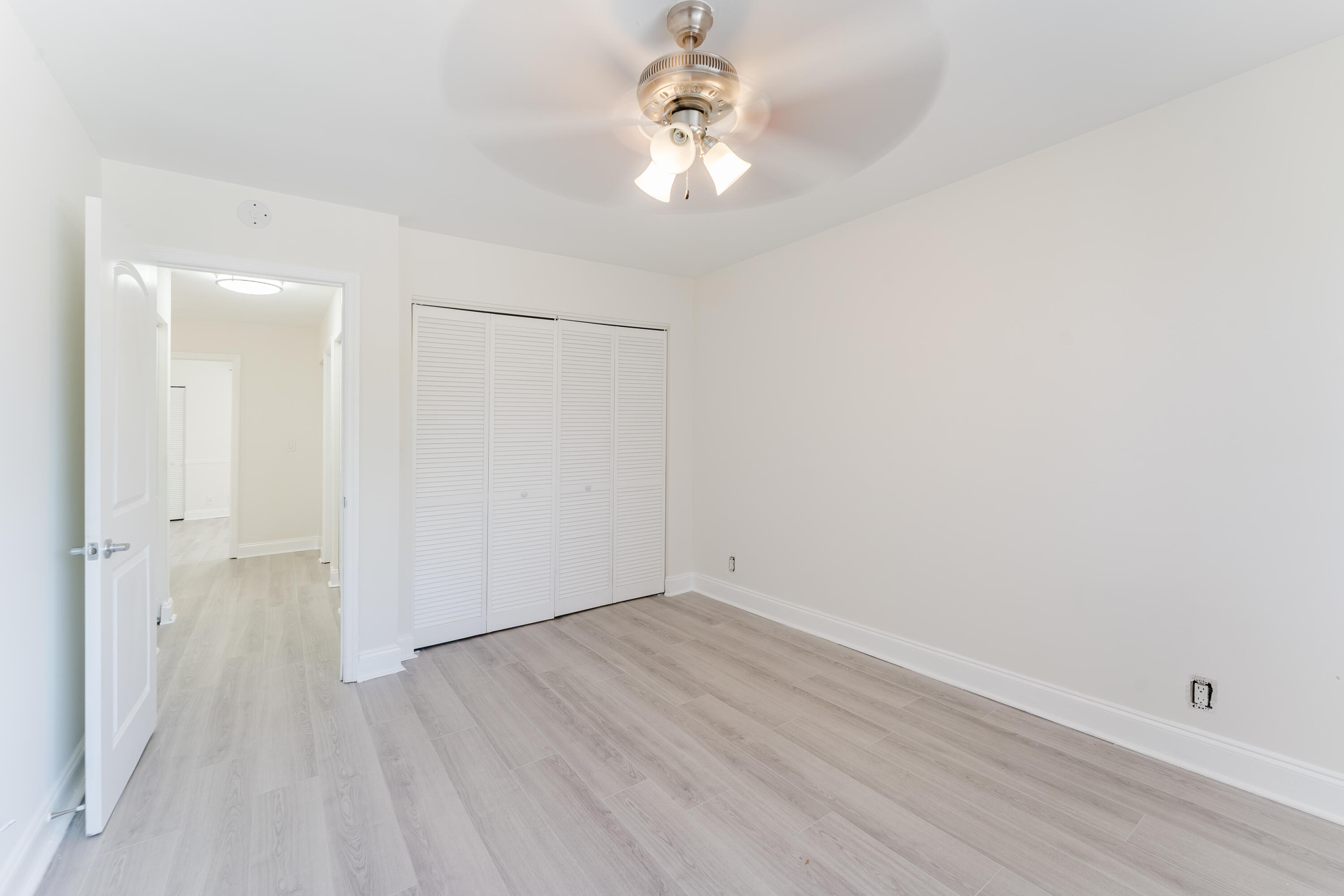 302 Northeast 36th Street Boca Raton, FL 33431 - Photo 24 of 40 a view of a room with wooden floor and a ceiling fan