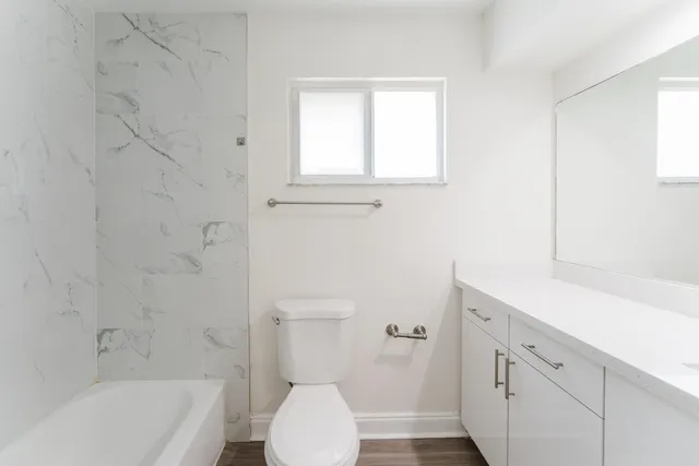 a bathroom with a sink a toilet and bathtub