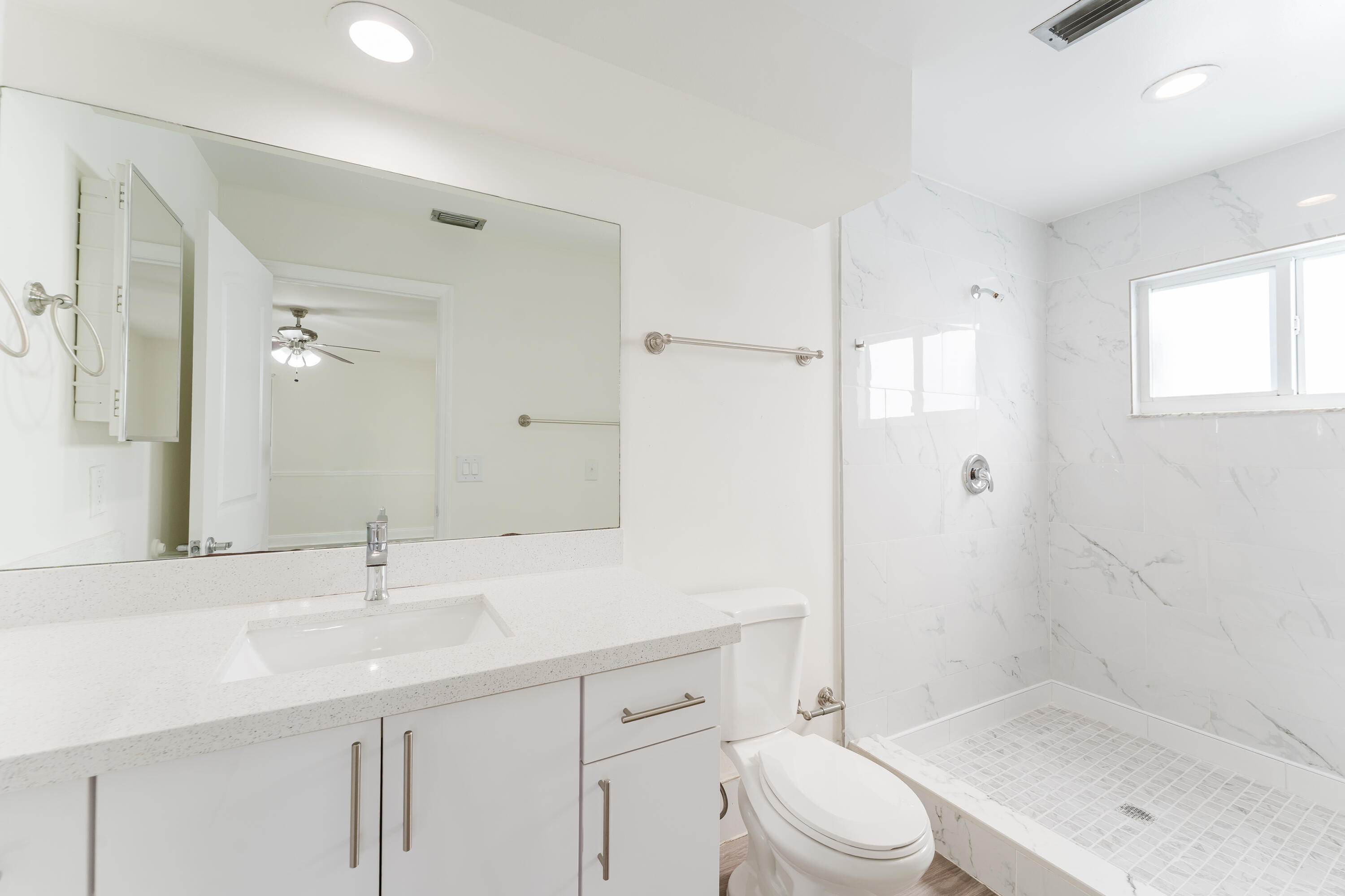 302 Northeast 36th Street Boca Raton, FL 33431 - Photo 31 of 40 a bathroom with a sink a toilet and shower