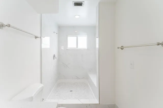 a bathroom with a glass shower door