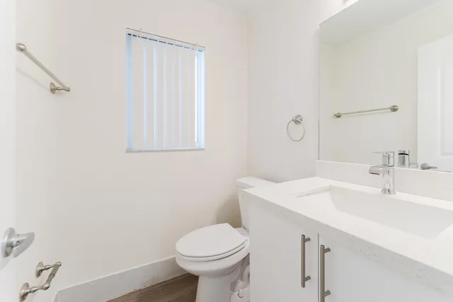 a bathroom with a sink toilet and vanity