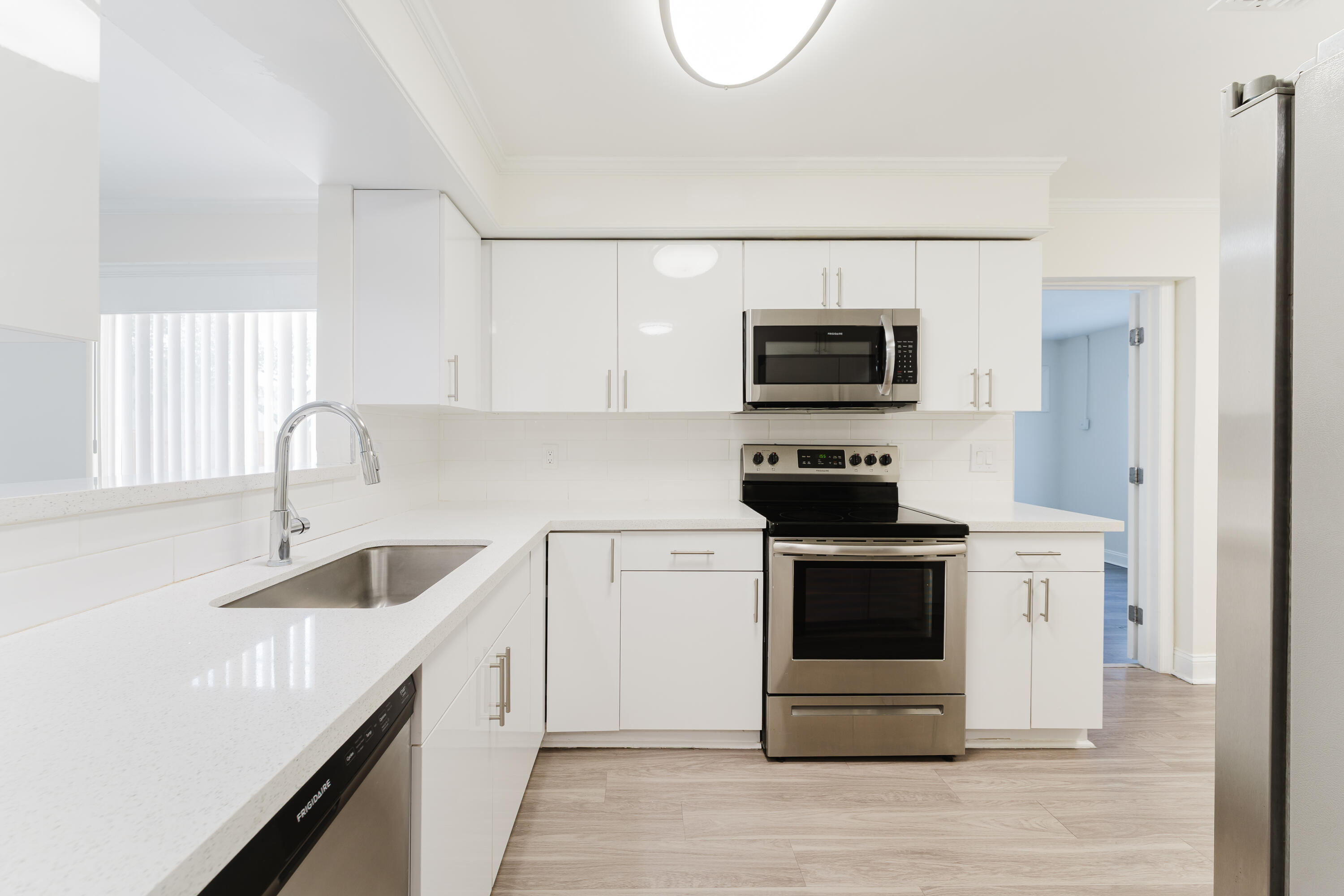 302 Northeast 36th Street Boca Raton, FL 33431 - Photo 8 of 40 a kitchen with a sink and a stove top oven
