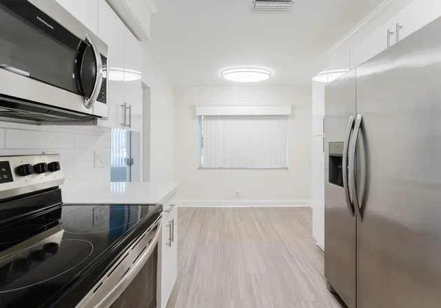 a kitchen with a refrigerator and a sink