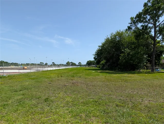 a view of a field with an trees