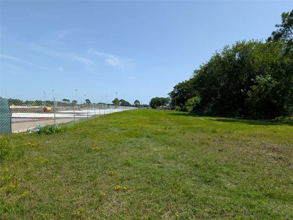 a view of a green field with lots of bushes